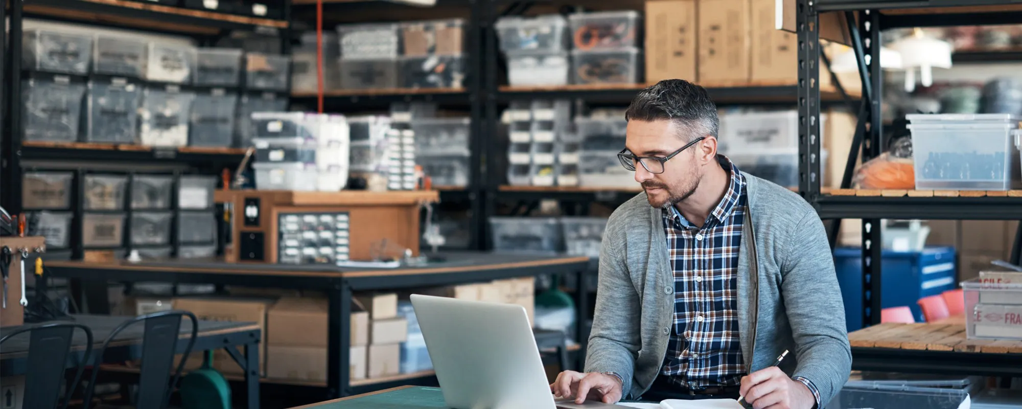 Man reviews his business expenses on a laptop